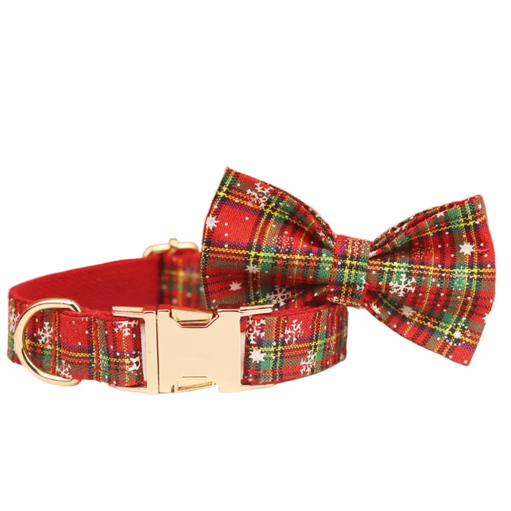 Red snowflake plaid dog collar and leash set with matching vest and decorative bow.