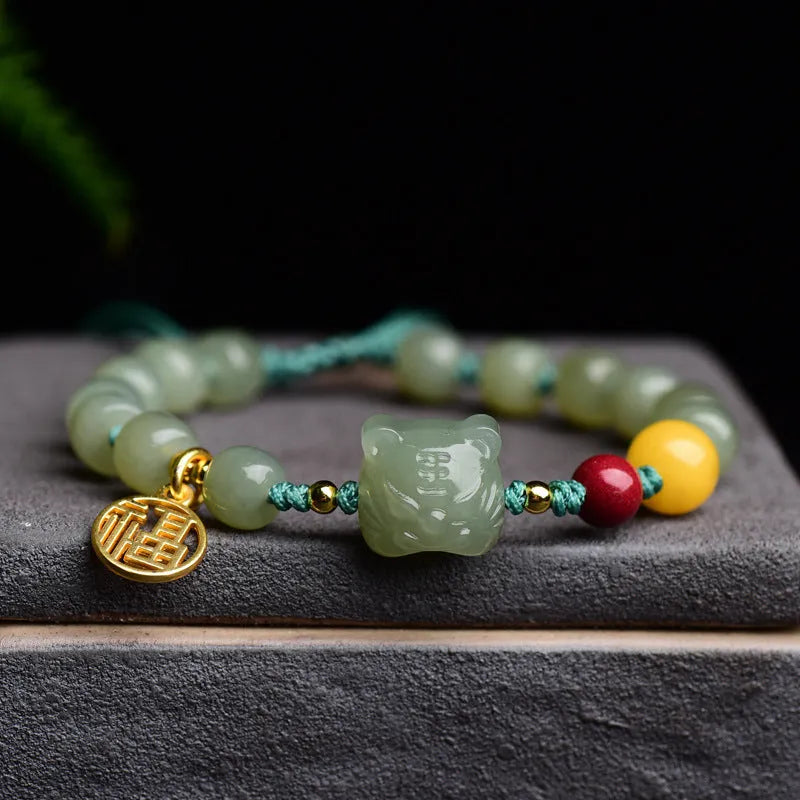 Natural Hetian Jade bracelet with cinnabar and beeswax beads, showing Zodiac modelling on 5x7mm beads.