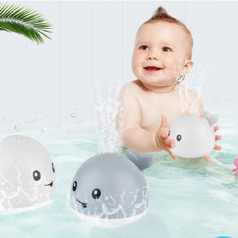 Whale-shaped electric bath toy with automatic water spray, LED lights, and music functions for baby sensory development