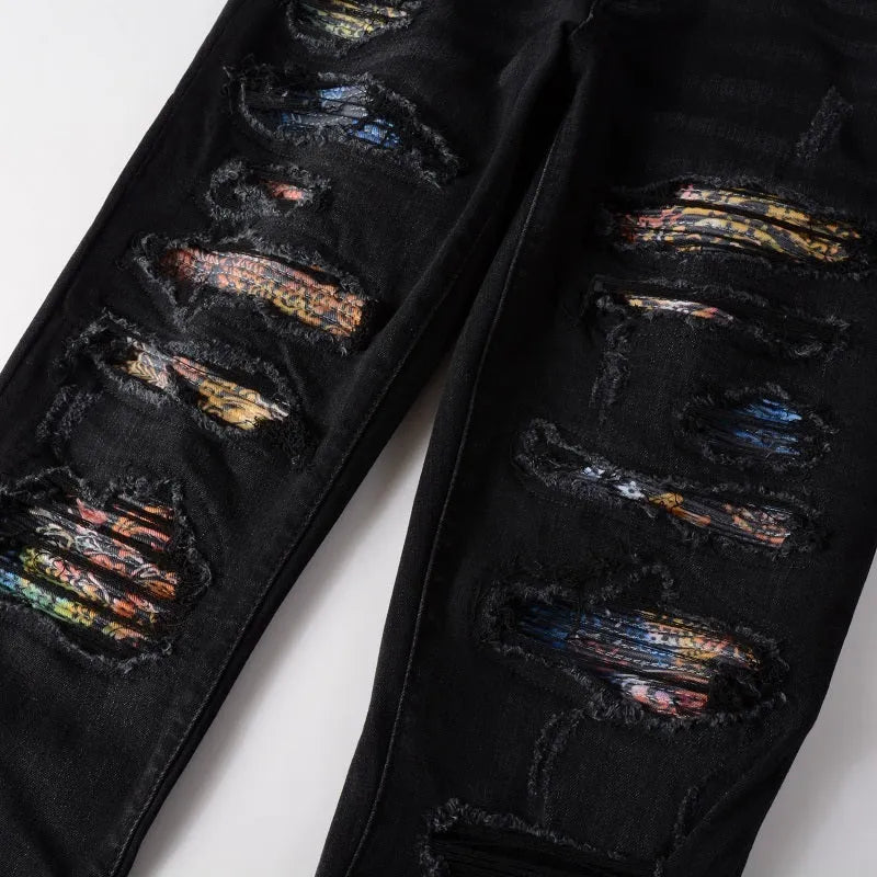 Men's black denim jeans with tattered hem and simple print patch detail