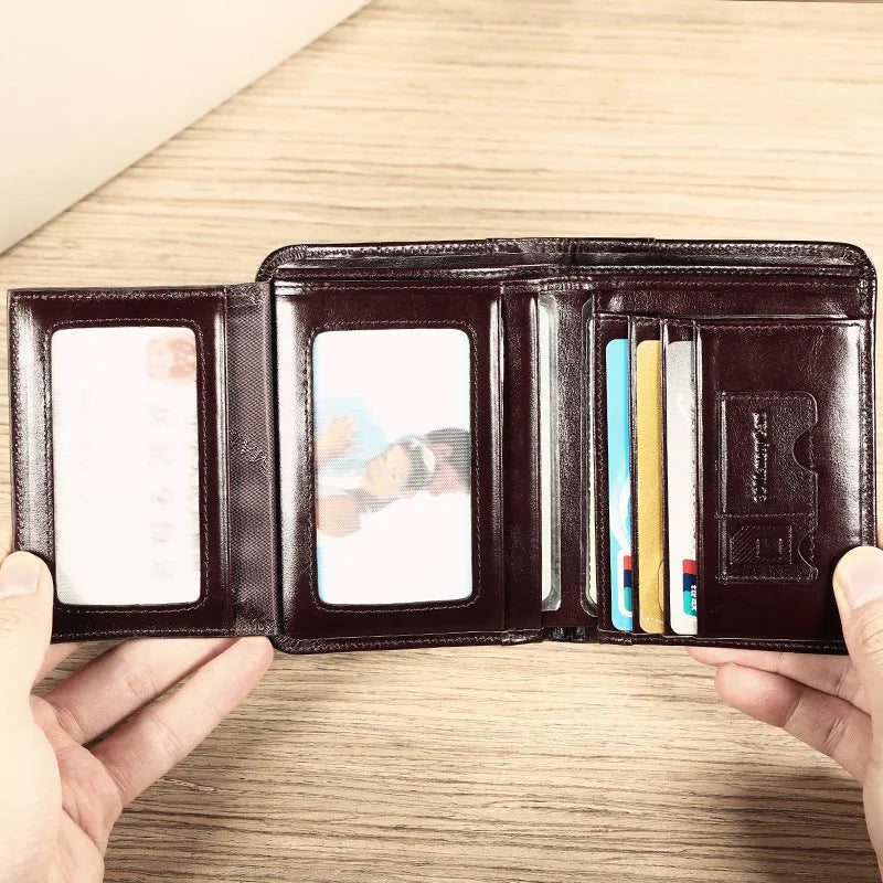 Men's black leather bifold wallet open to show card slots, coin pocket, and photo window.