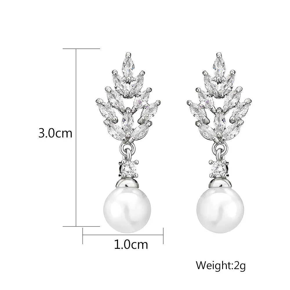 Geometric flower-shaped earrings with micro-inlaid zircon stones and pearl accents in gold, platinum, or rose gold plating.