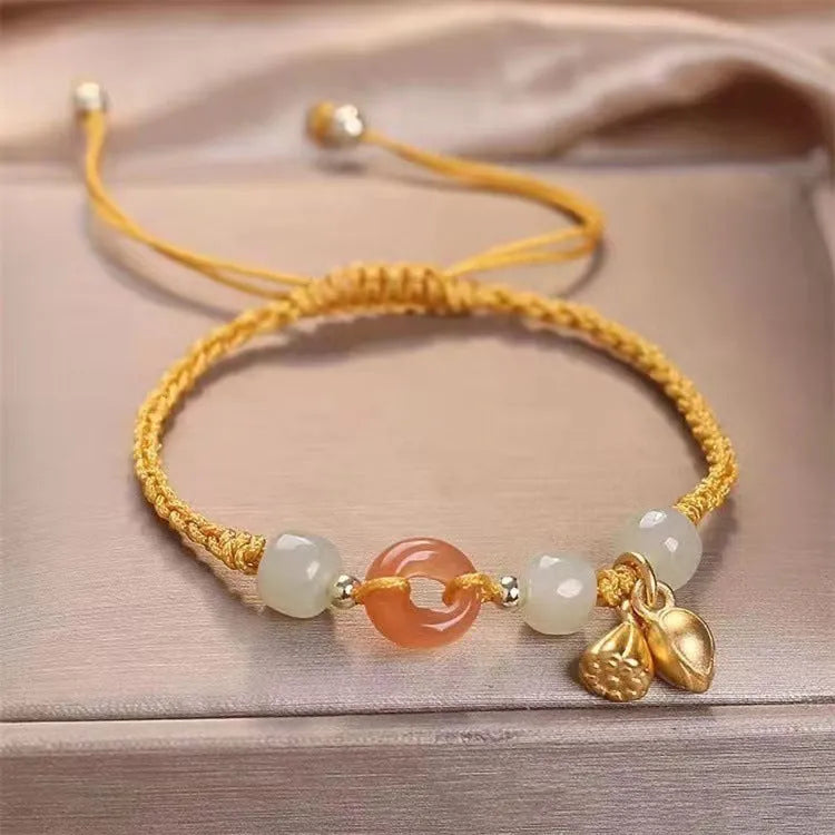 Hetian jade peace buckle bracelet on a brown strap, showing constellation detail.