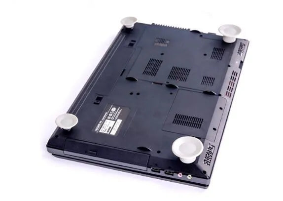 Grey plastic laptop cooling pad set showing two large and two small non-slip pads on a desk.