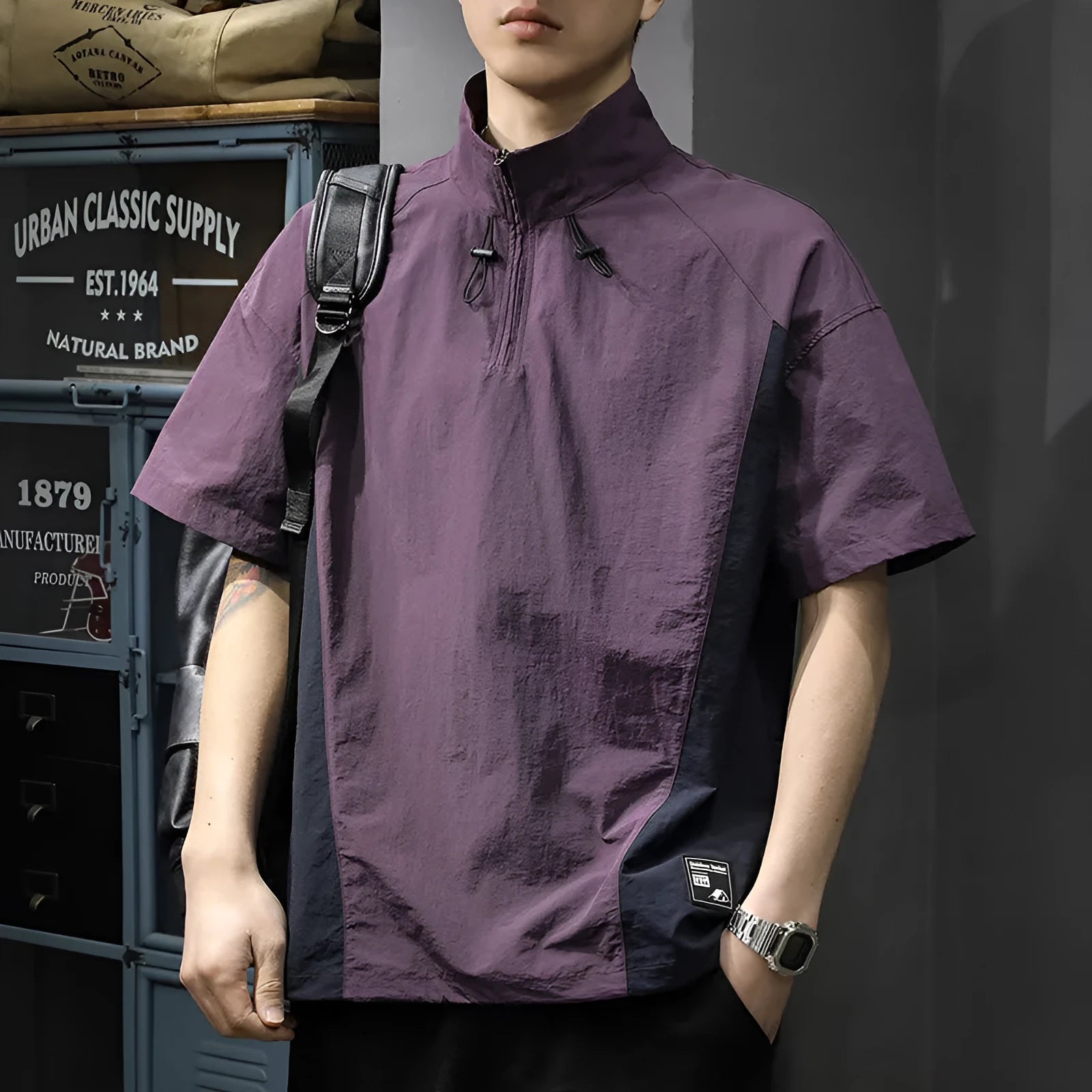 Brown men's half-zip stand collar short-sleeve shirt on a hanger, showing loose fit and ice silk fabric texture.