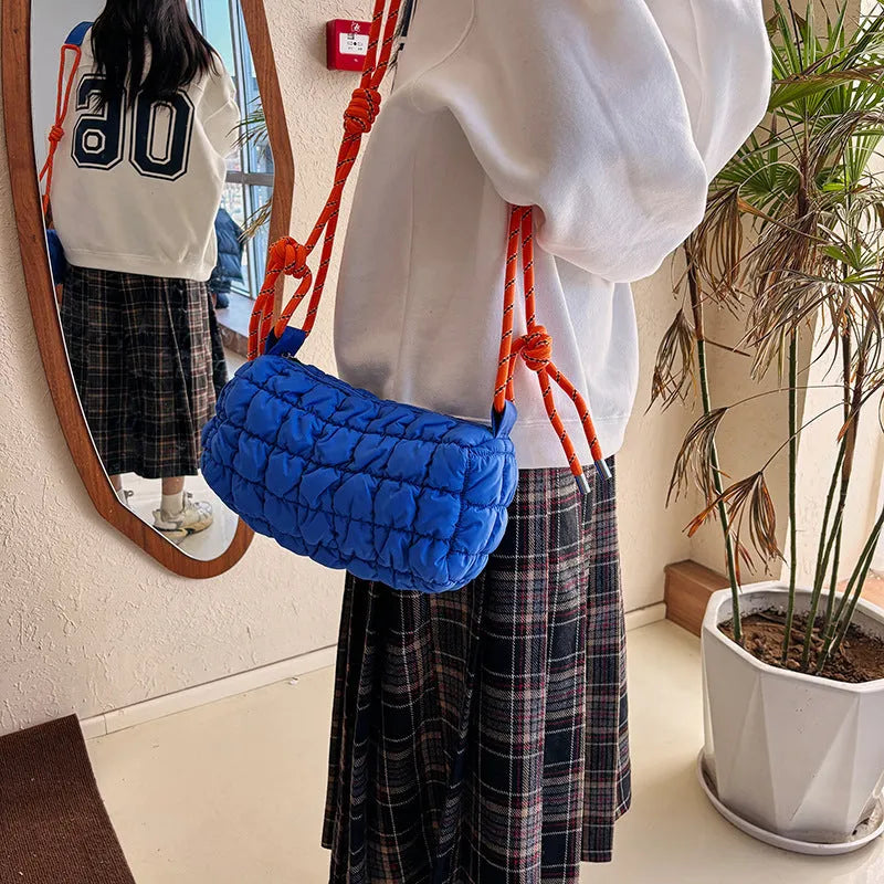 Women's lightweight nylon messenger bag in pillow shape with a crossbody strap, shown in rose red with a rhombus pattern.