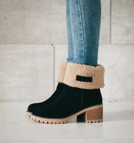 Women's black suede mid-tube snow boots with a thick flat heel and round toe on a white background.