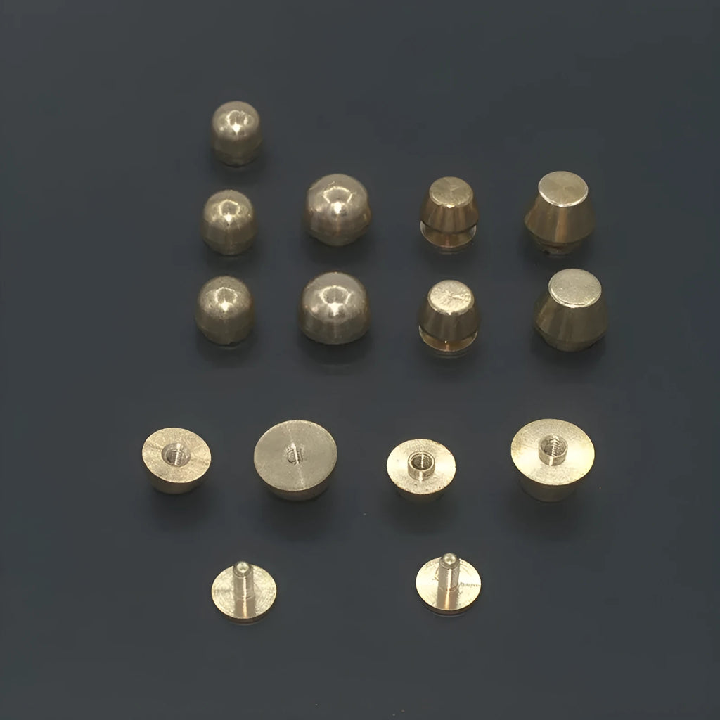 Assortment of brass decorative buckles in antique gold finish showing round foot nail and bucket foot nail designs