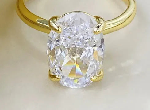 Oval gemstone ring in a four-claw setting on a silver band.