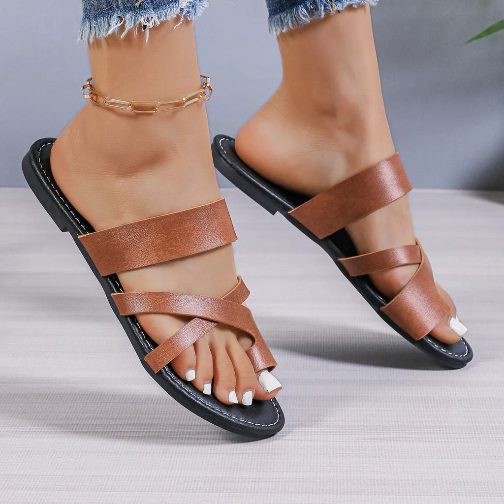 Solid colour round toe beach slippers with a one-strap design and perforated hollow out details on the sole.