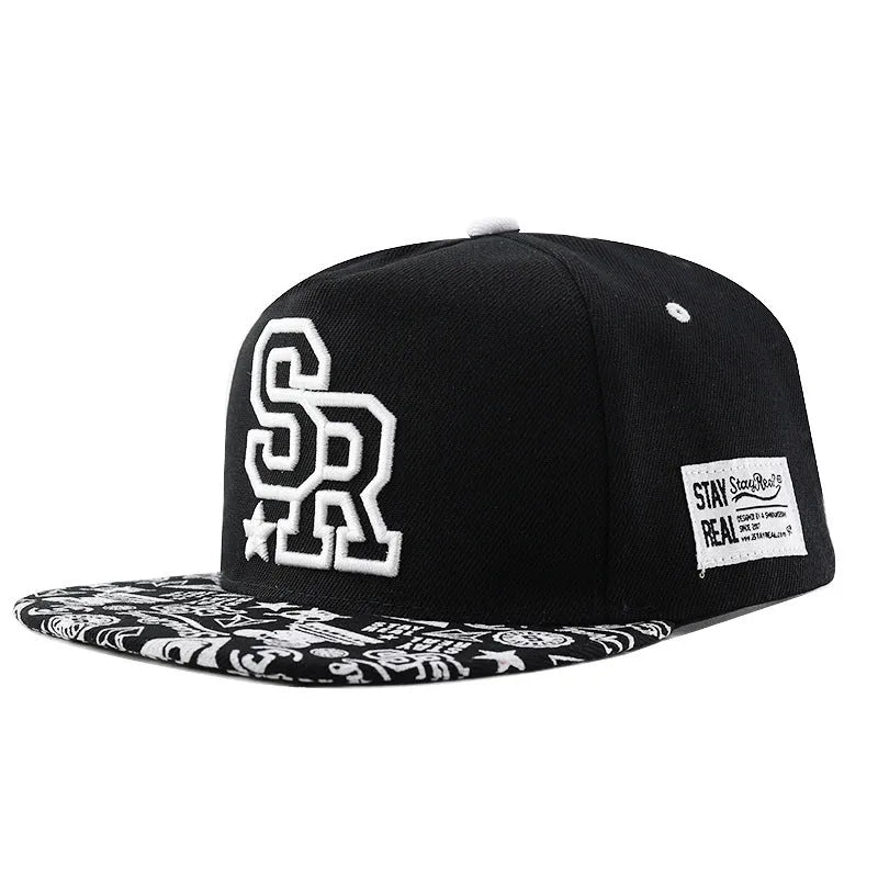 Cotton baseball cap with embroidered lettering on the front, shown in black and white colours