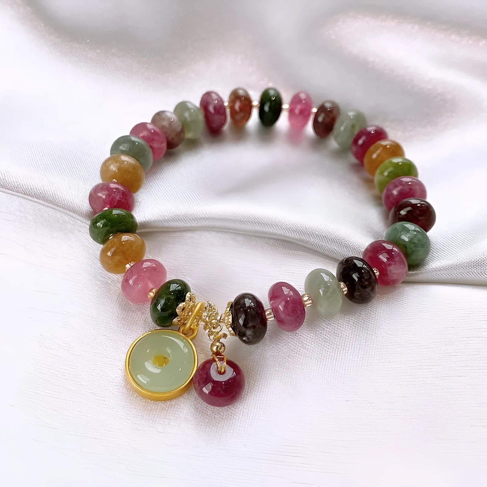 Colourful natural tourmaline abacus bead bracelet with a rabbit pendant charm.