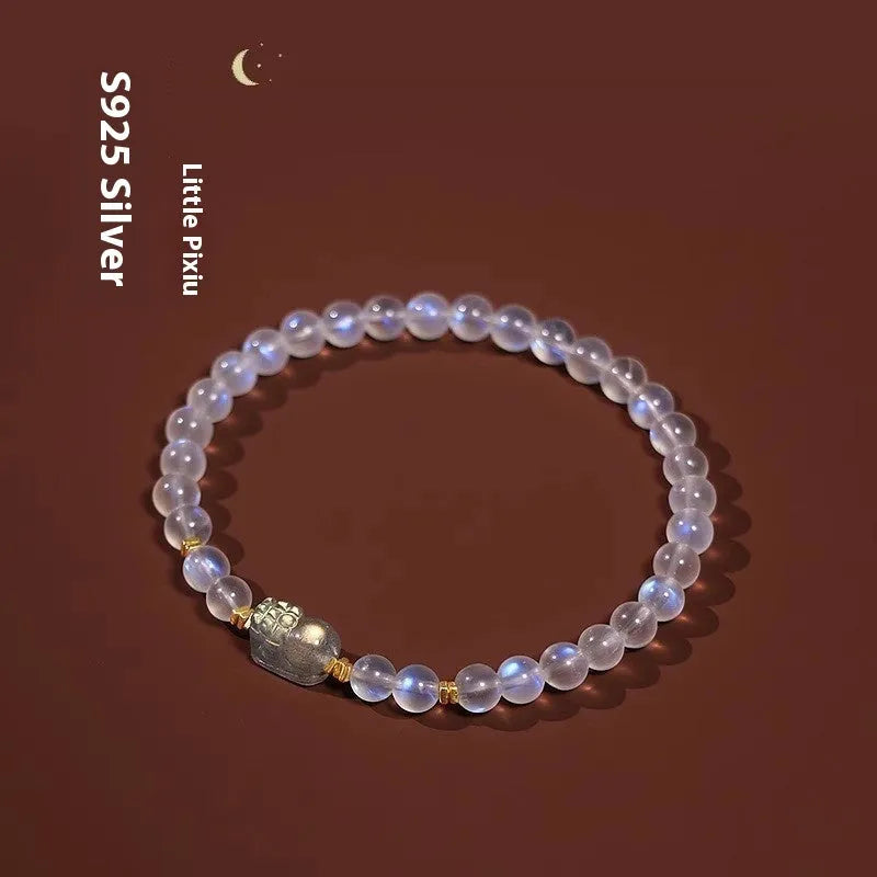 Close-up of a women's moonstone bracelet with zodiac animal design in a traditional Chinese style.