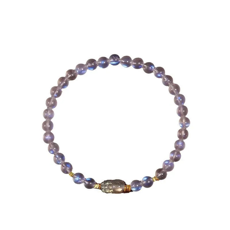 Close-up of a women's moonstone bracelet with zodiac animal design in a traditional Chinese style.