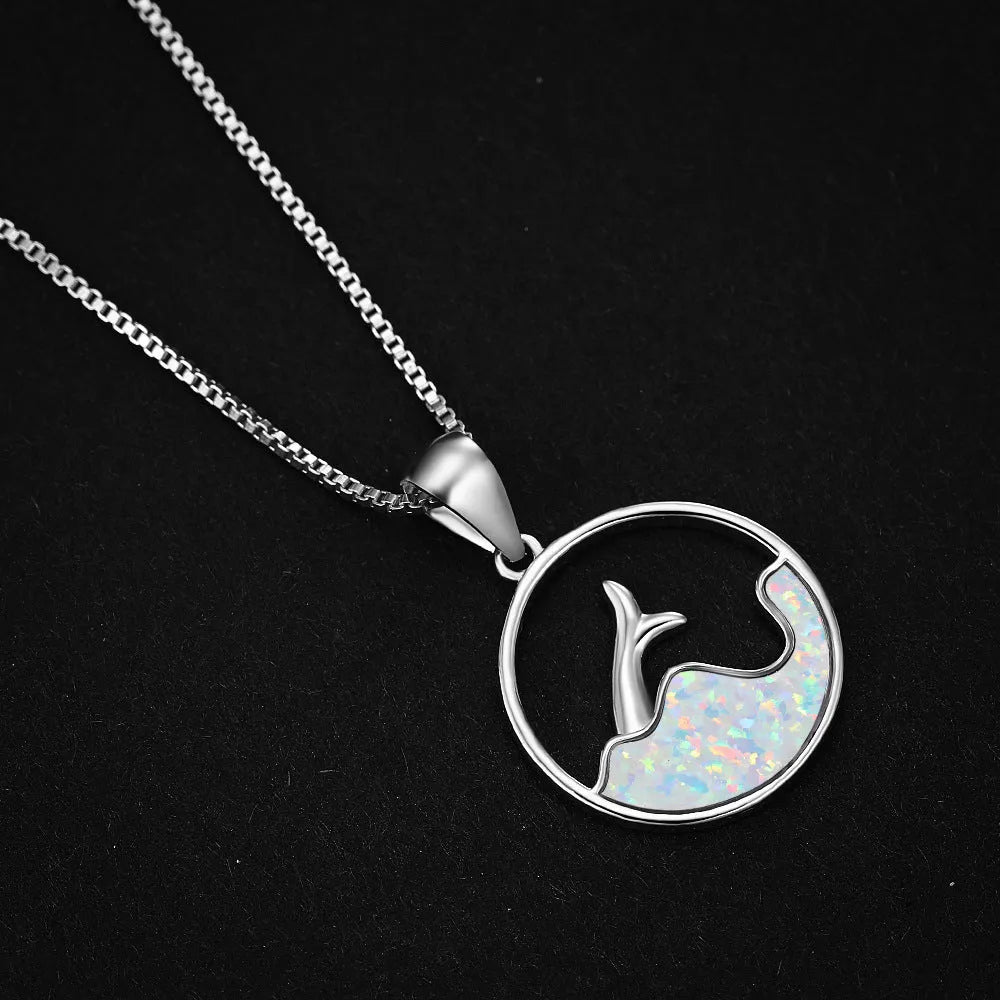 White gold plated fishtail pendant necklace with round blue opal stone on a 45 cm chain.