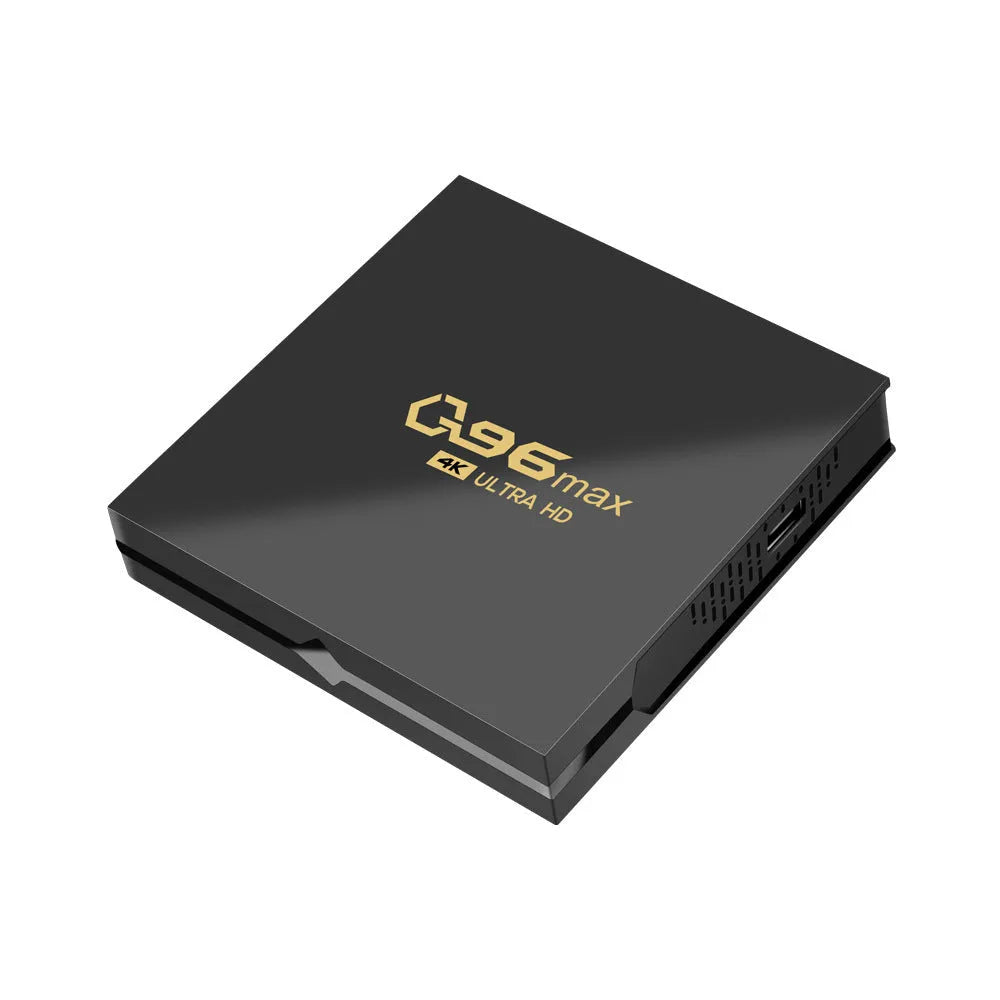 Q96 MAX S905 Android 4K TV Box set-top unit with remote control on a table.