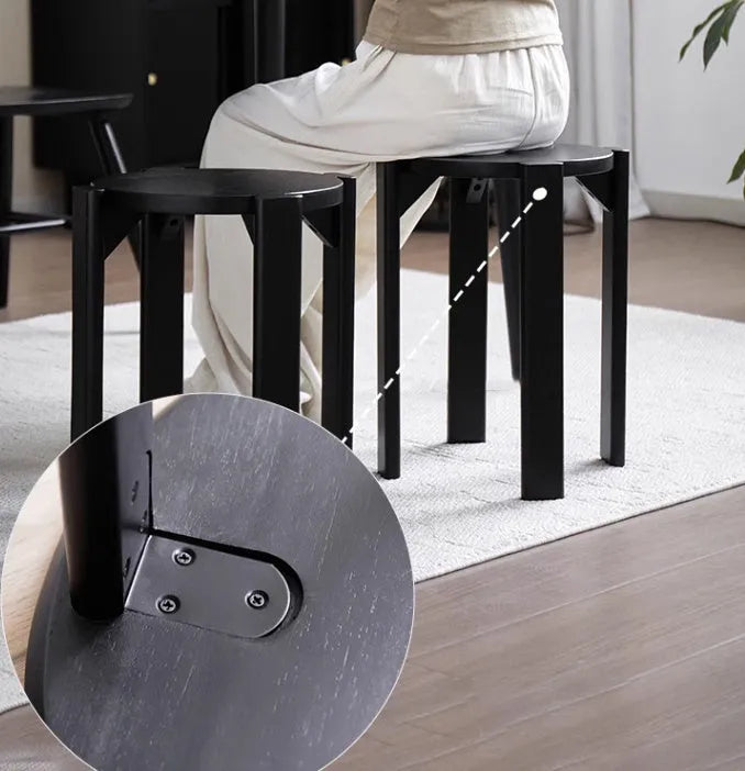 Stackable round iron dining stool in a modern style, shown in one of four available colours.