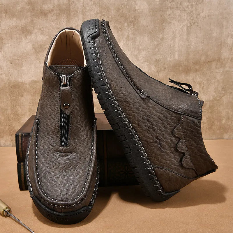 Men's black slip-on leather loafers with round toe and rubber sole on a white background