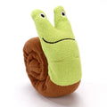 Reversible squeak dog snuffle toy in snail shape with hidden food holes, made of thick green velvet.