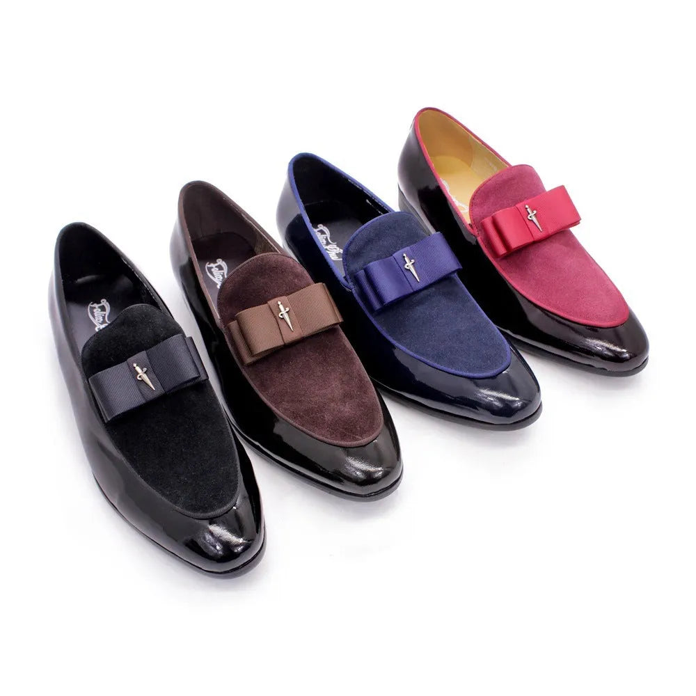 Men's black patent leather low-top dress shoes with a tassel detail on a rubber sole.
