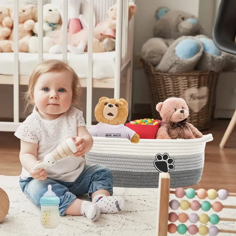 Small light beige woven cotton rope storage basket with a handle on a wooden surface