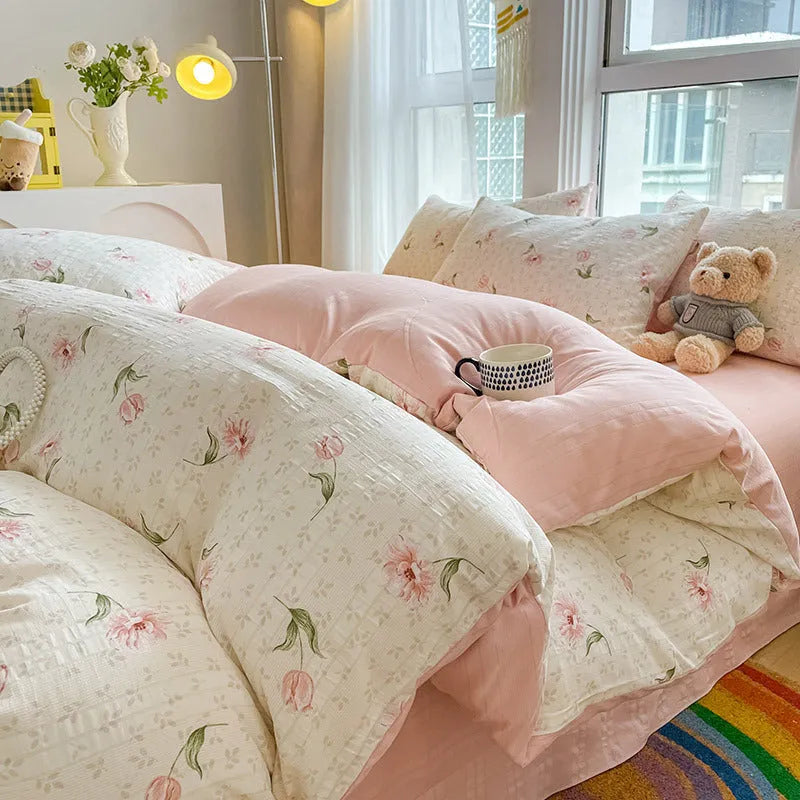 Aerobic jacquard cloud yarn four-piece bedding set with quilt cover, sheet, and pillowcases in a soft pattern.