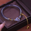 Grey smoke purple agate half bracelet with a metal ring buckle closure on a wrist.