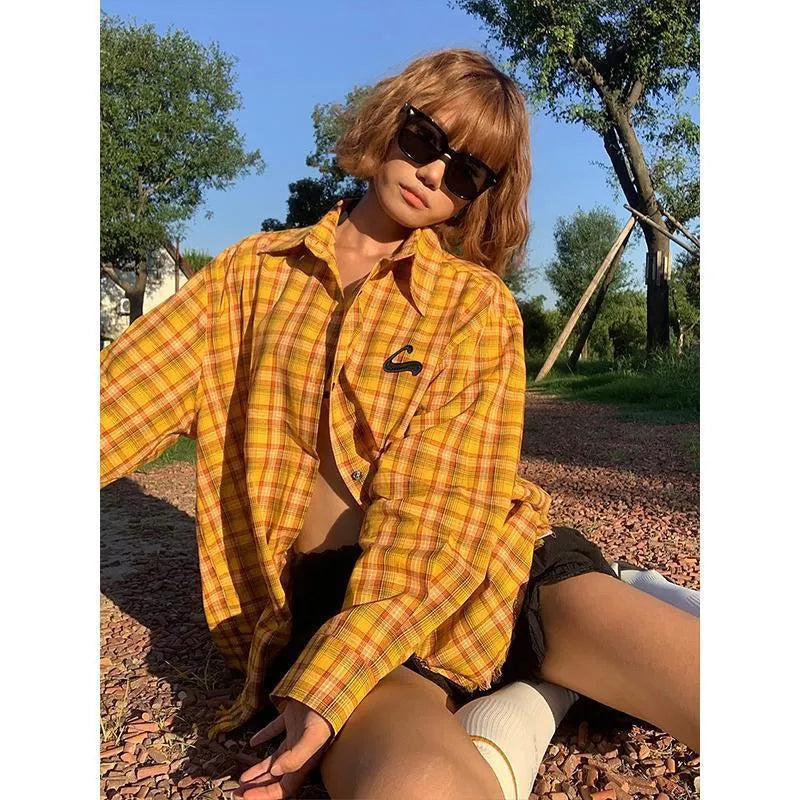 Yellow and black plaid shirt with a loose cardigan-style fit on a hanger.