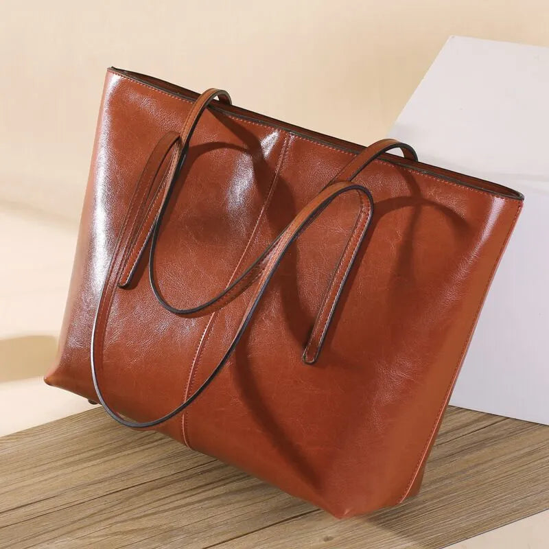 Women's retro style cowhide shoulder bag in horizontal square shape with multiple internal compartments
