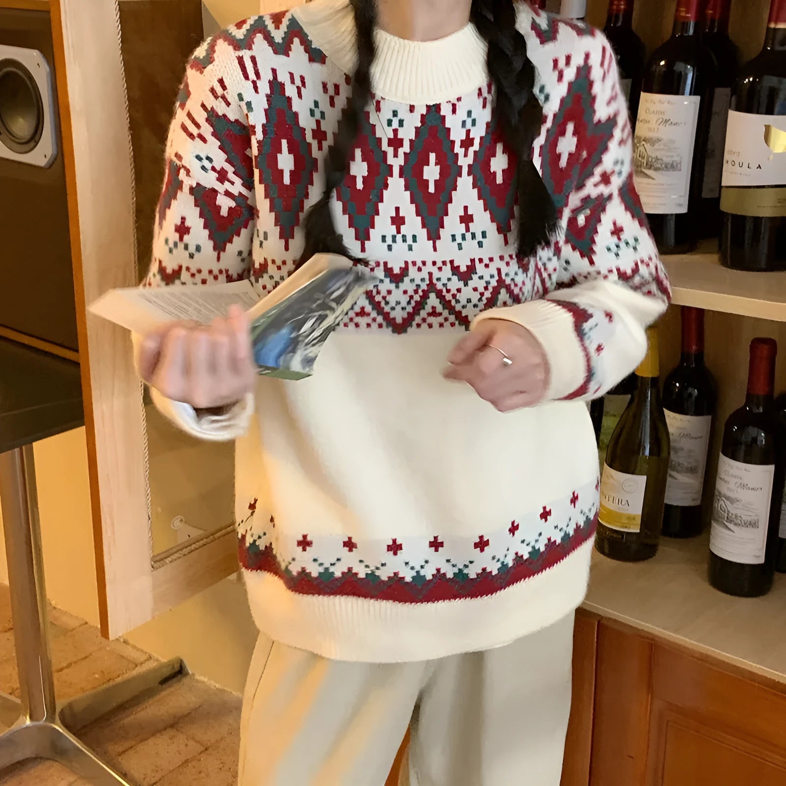 Red and white striped loose-fit long sleeve pullover knitted top on a hanger.