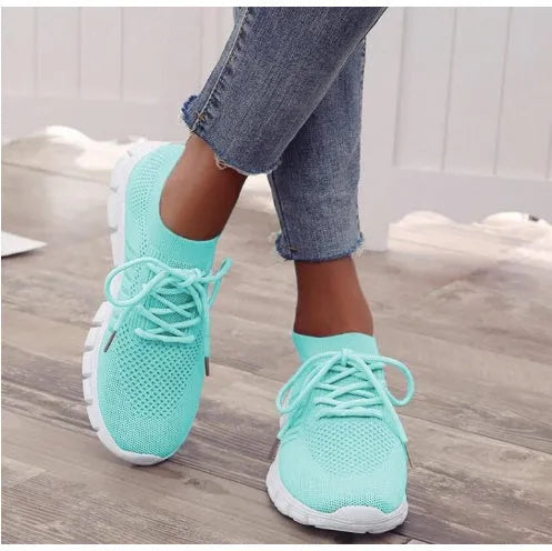 Women's breathable high-cut lace-up casual sneaker on a flat platform heel with a rubber sole.