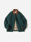 Green casual polyester jacket with side seam pockets on a hanger