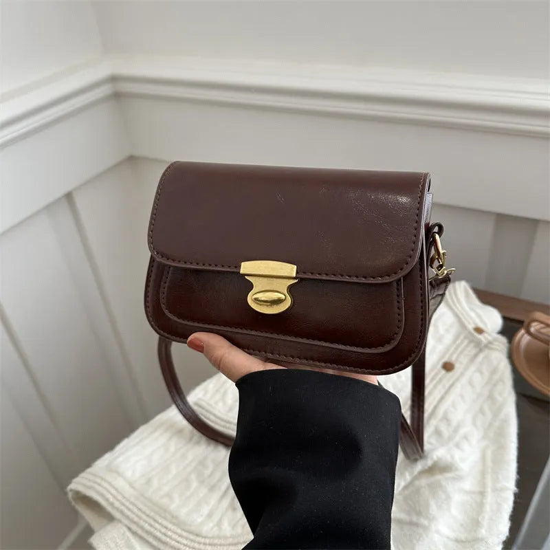 Soft PU leather small square handbag in horizontal rectangle shape shown in brown colour.