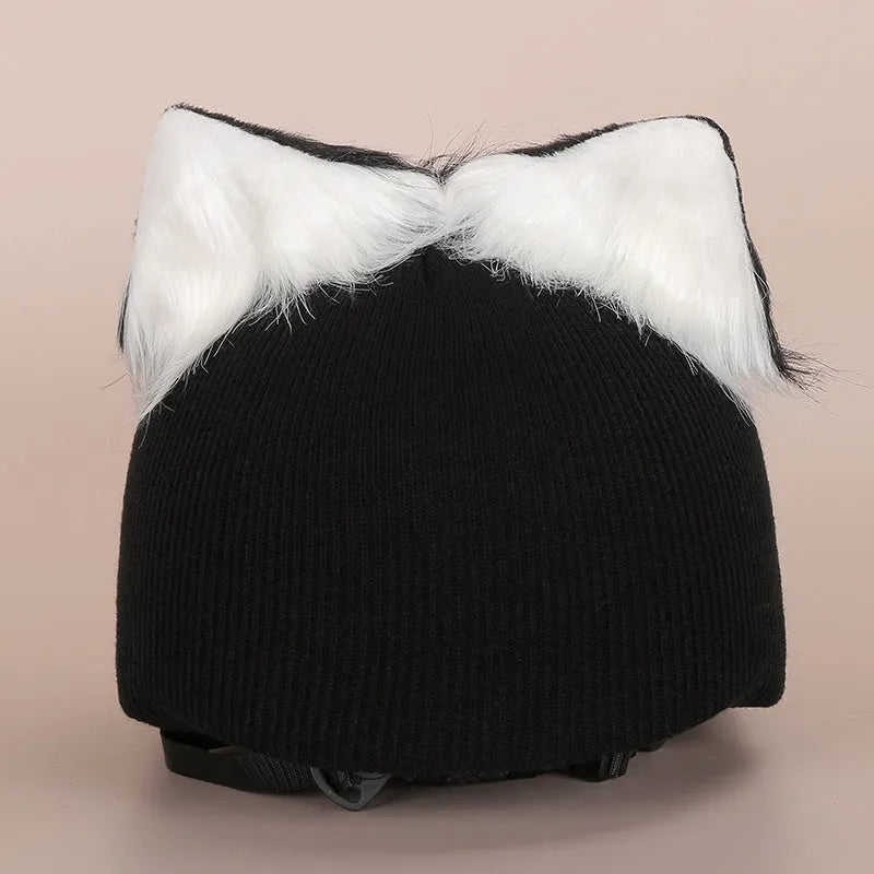 Plush cartoon-themed cover set on a medium motorcycle helmet with soft ear decorations.