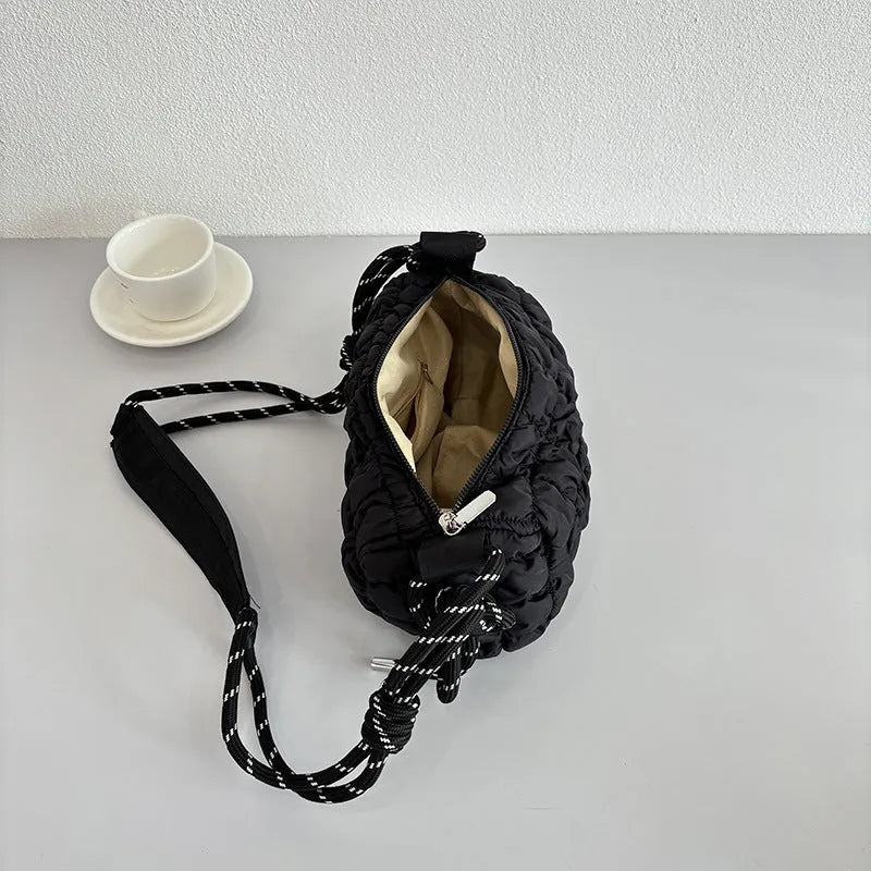 Women's lightweight nylon messenger bag in pillow shape with a crossbody strap, shown in rose red with a rhombus pattern.