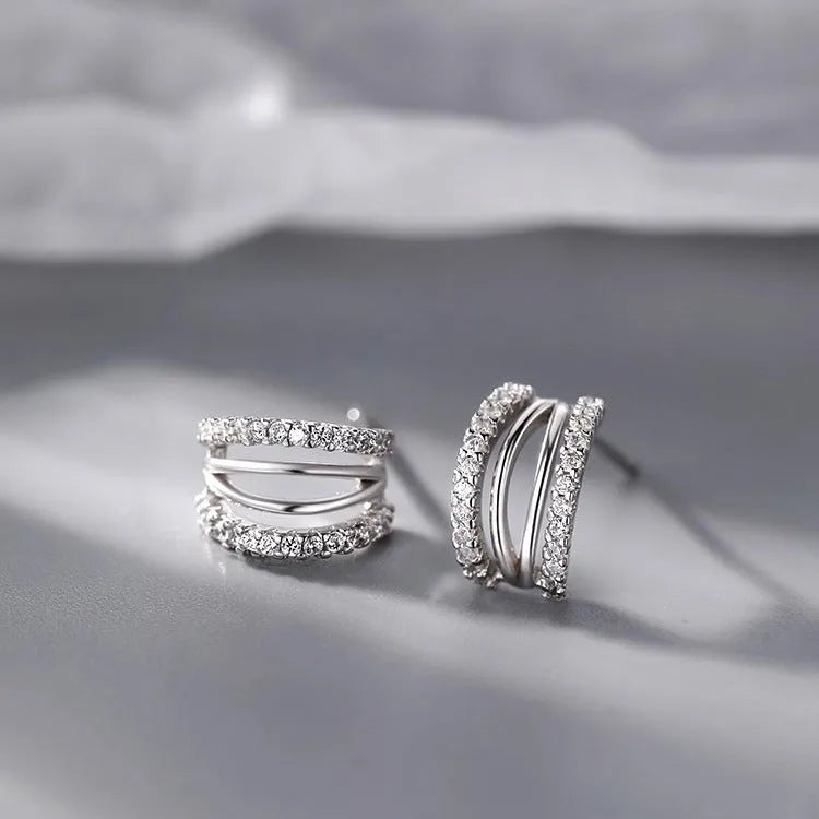 A pair of geometric-shaped 925 silver earrings with silver needle posts, shown in three available sizes.