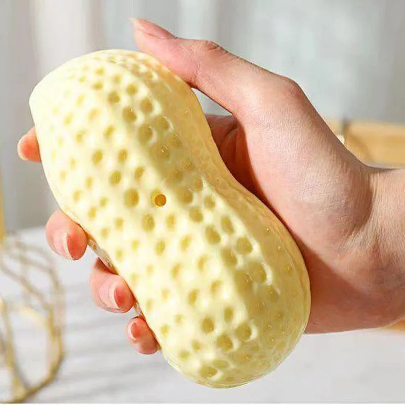 Yellow TPR peanut-shaped dog chew toy with textured surface for dental cleaning
