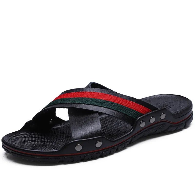Men's black cowhide leather flip-flop sandals with a non-slip PU sole on a wooden deck.