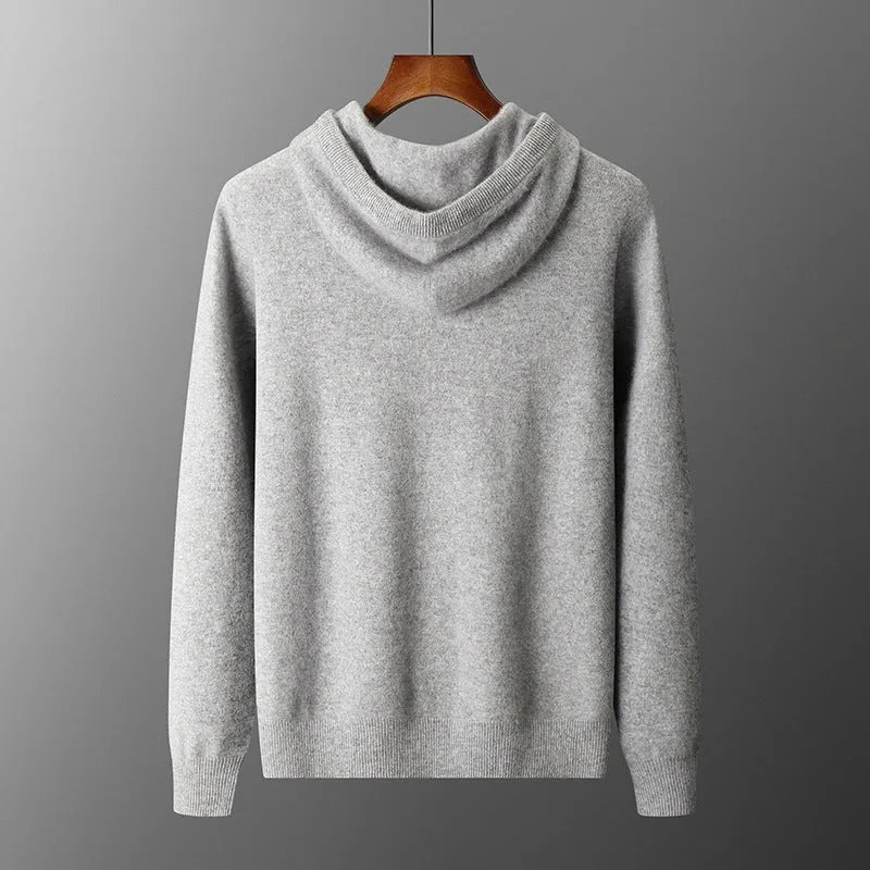 Man wearing a light grey hooded cashmere sweatshirt and matching casual trousers.