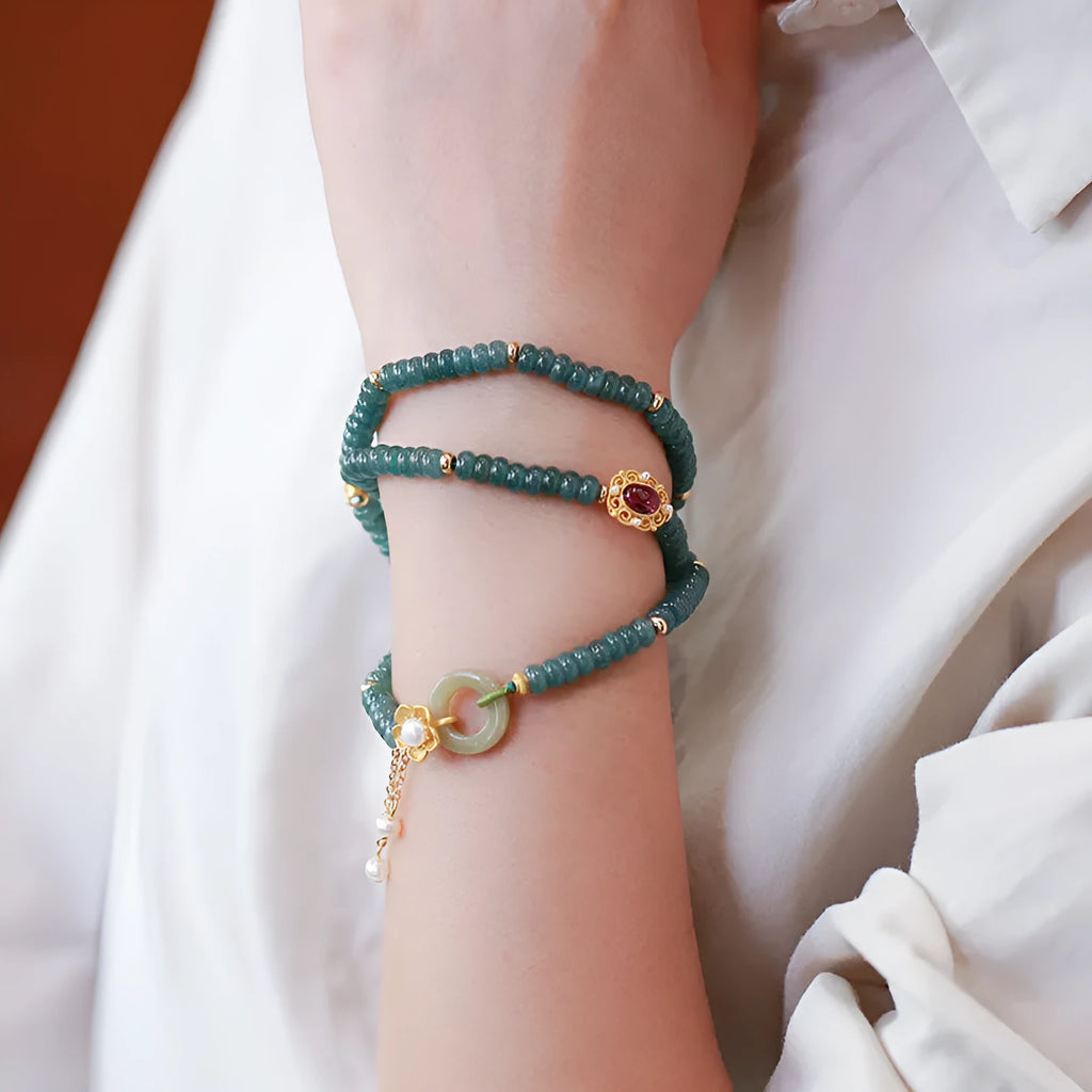Blue water jade abacus bead bracelet with three silver rings and tourmaline pearls