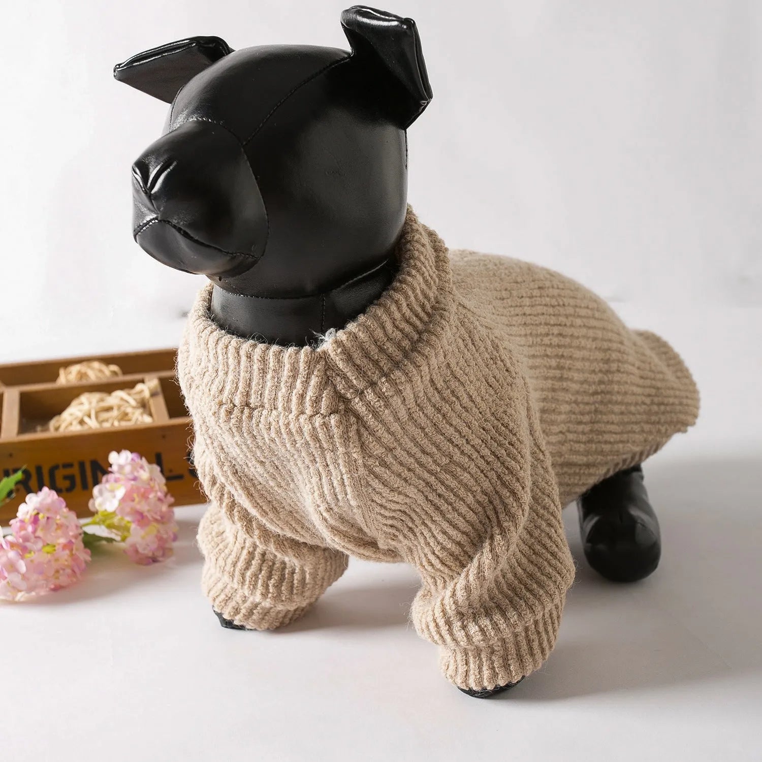Brown knitted pullover sweater on a small dog, showing casual cloth design.