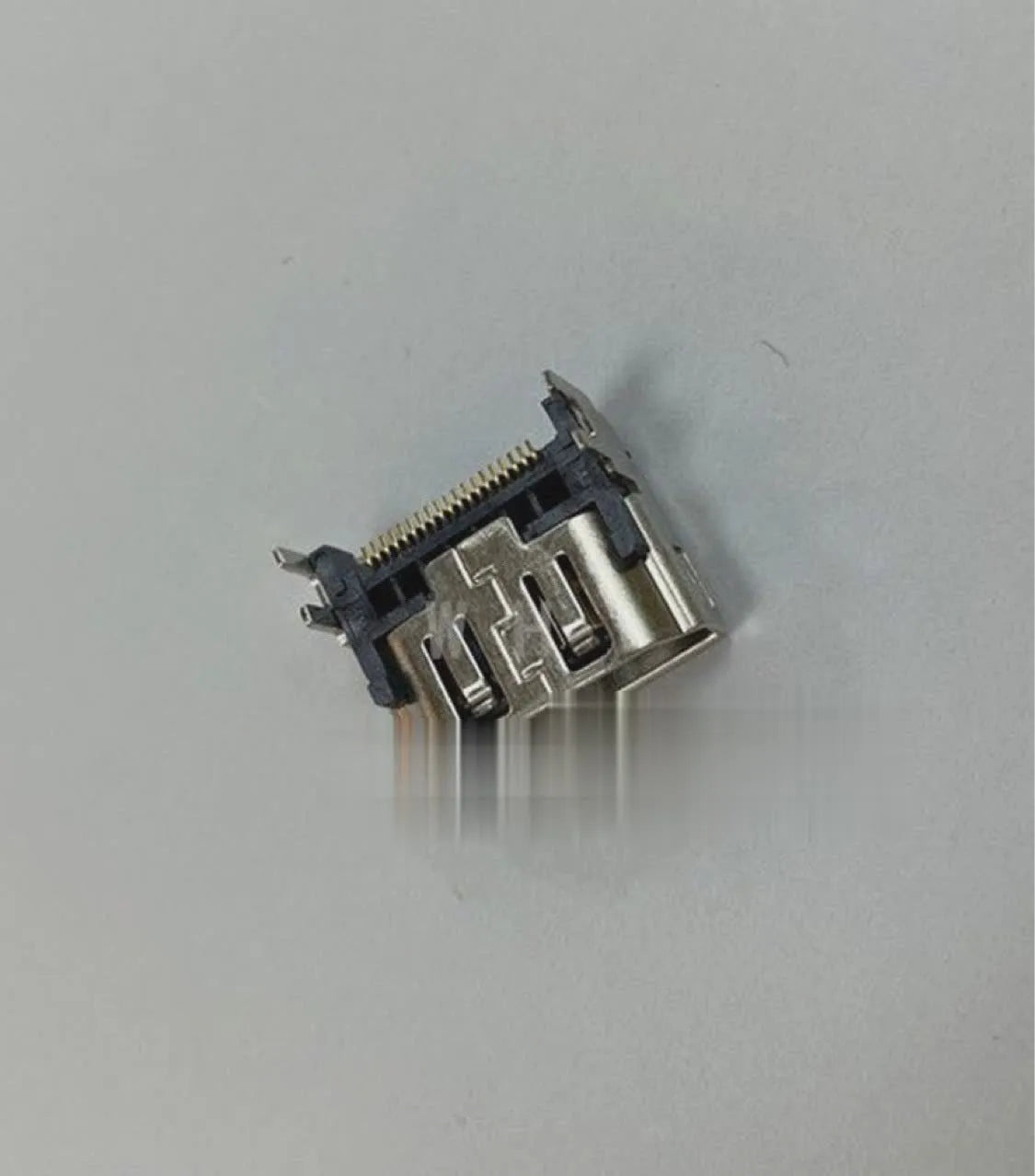 Silver HDMI host socket connector for game console repair.