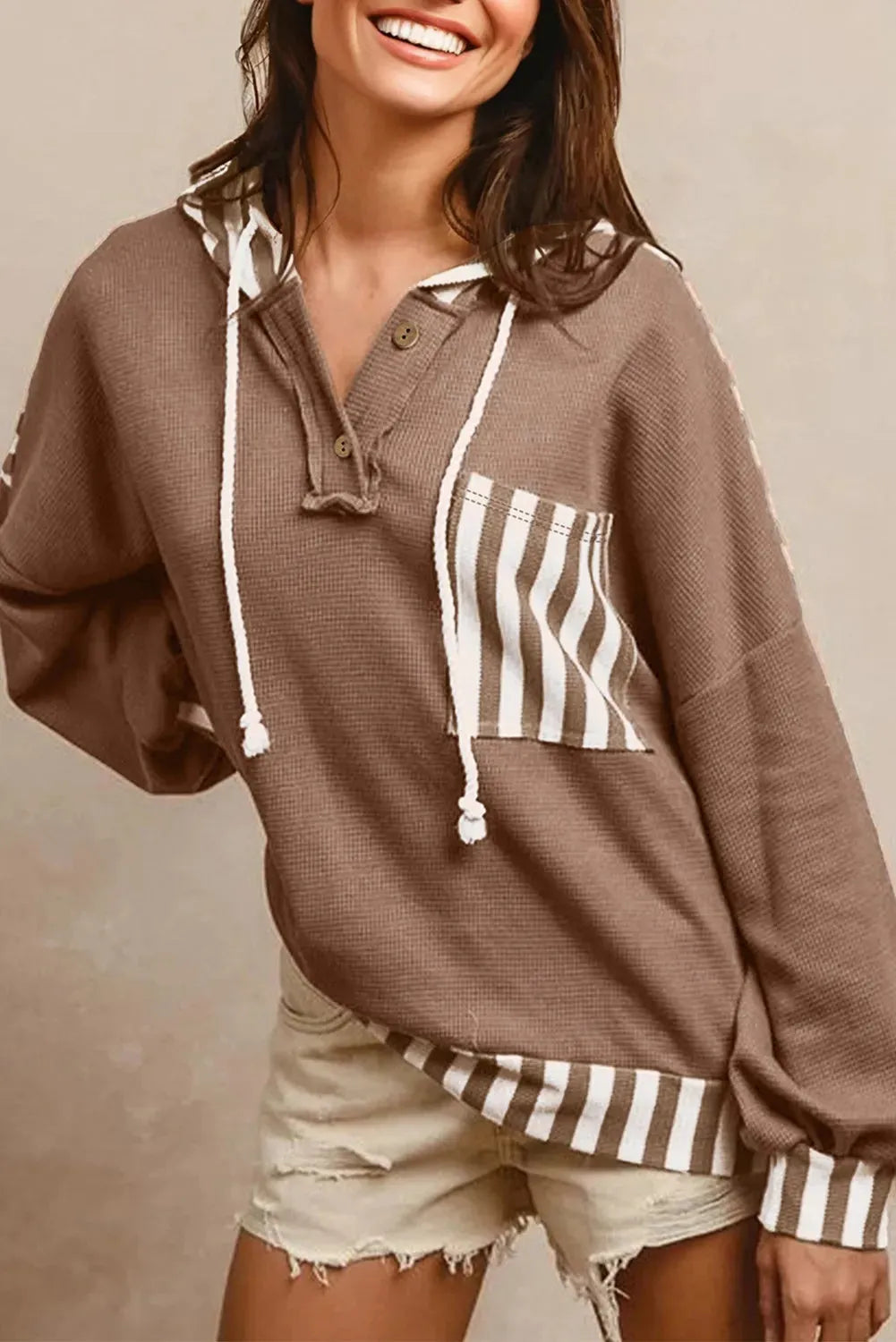 Straw yellow waffle texture striped patchwork hoodie with a button neck and drawstring hood.