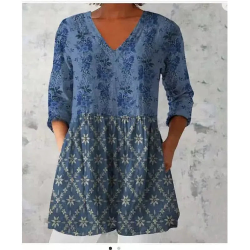Women's loose floral print dress with wide waist and 3/4 length wave-pattern sleeves.