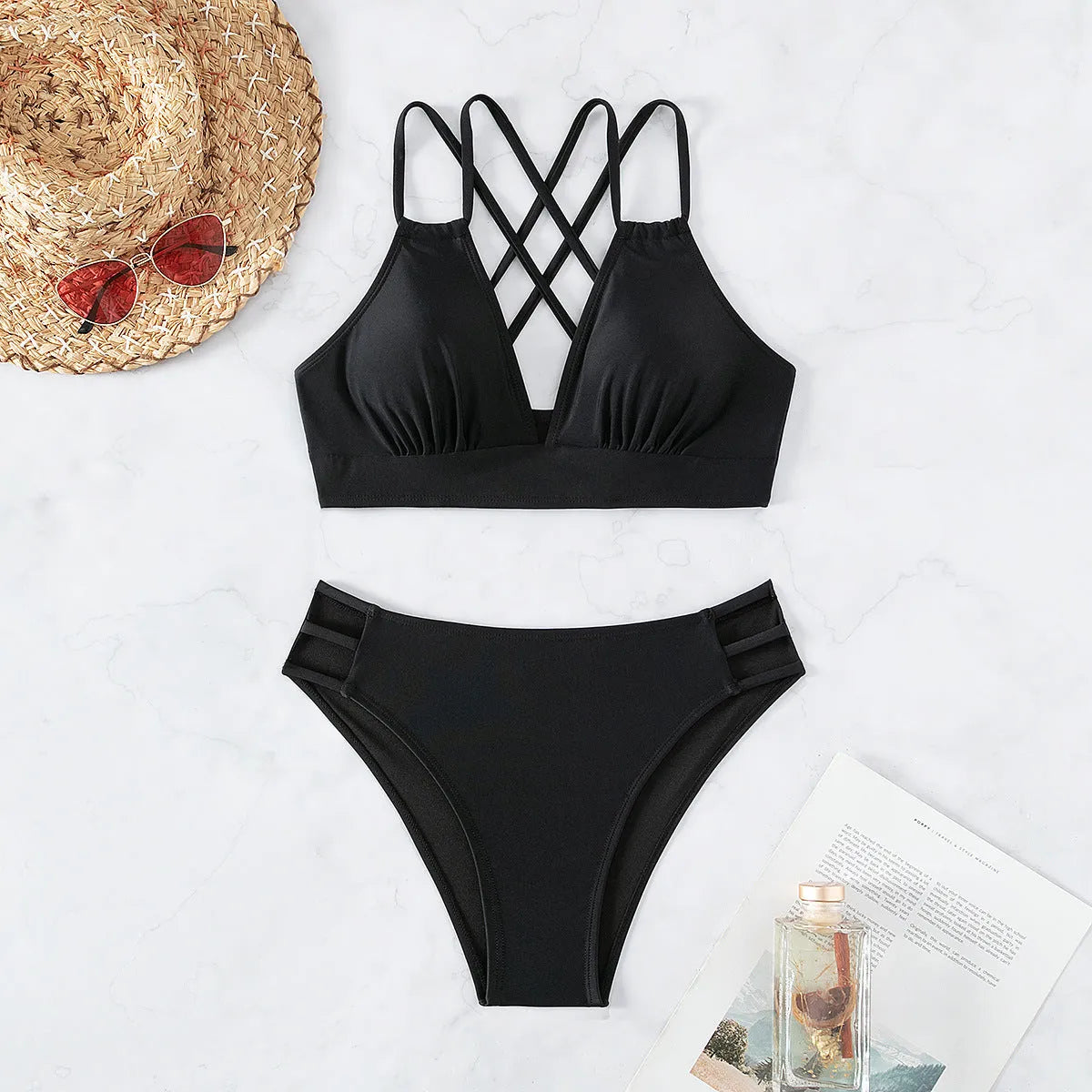 Women's black V-neck halter bikini swimsuit with bra and shorts on a mannequin