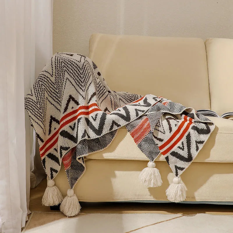 Acrylic bohemian-style blanket with tassel trim in a geometric pattern colour option