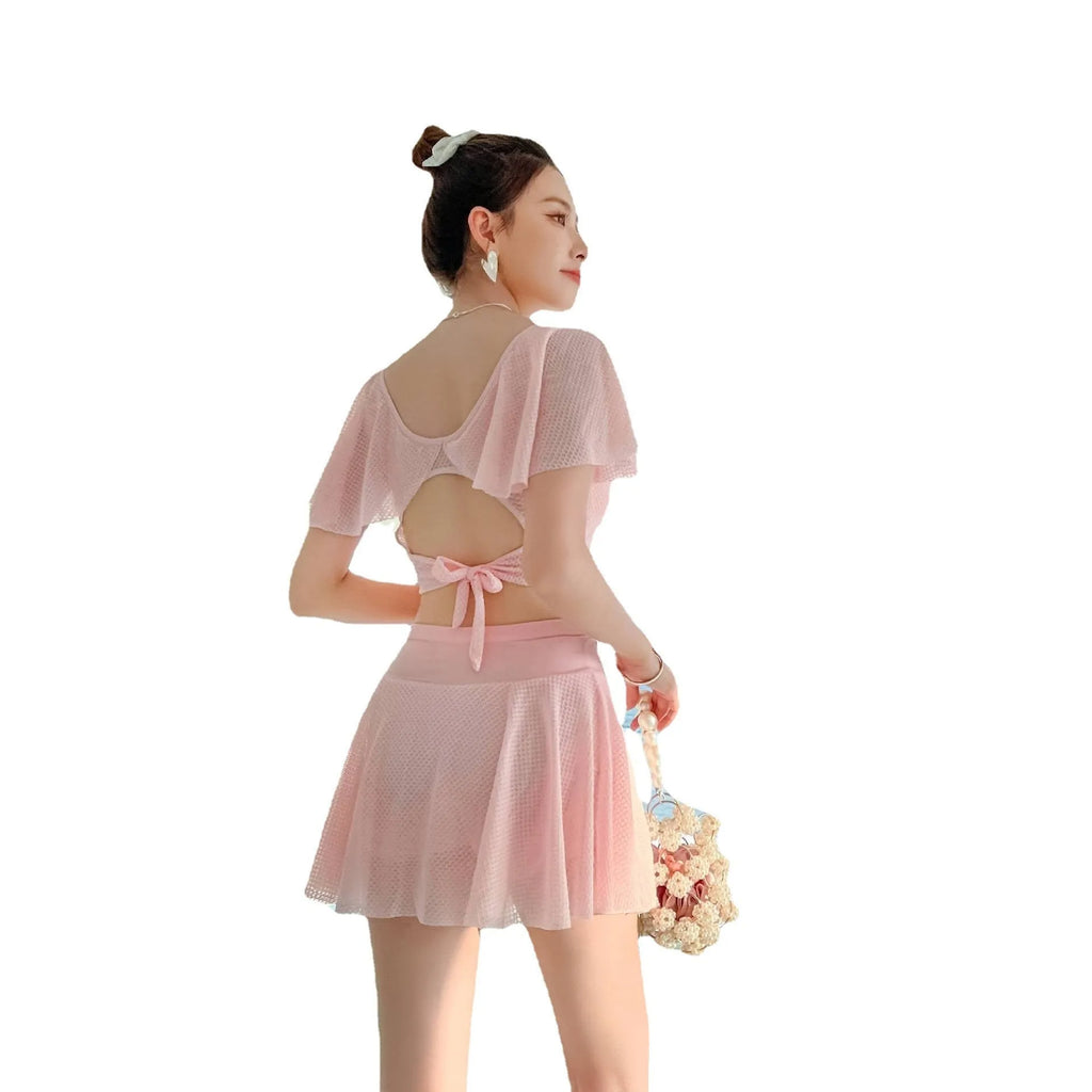 Women's solid colour two-piece skirt swimsuit set in black, white, or pink with separate top