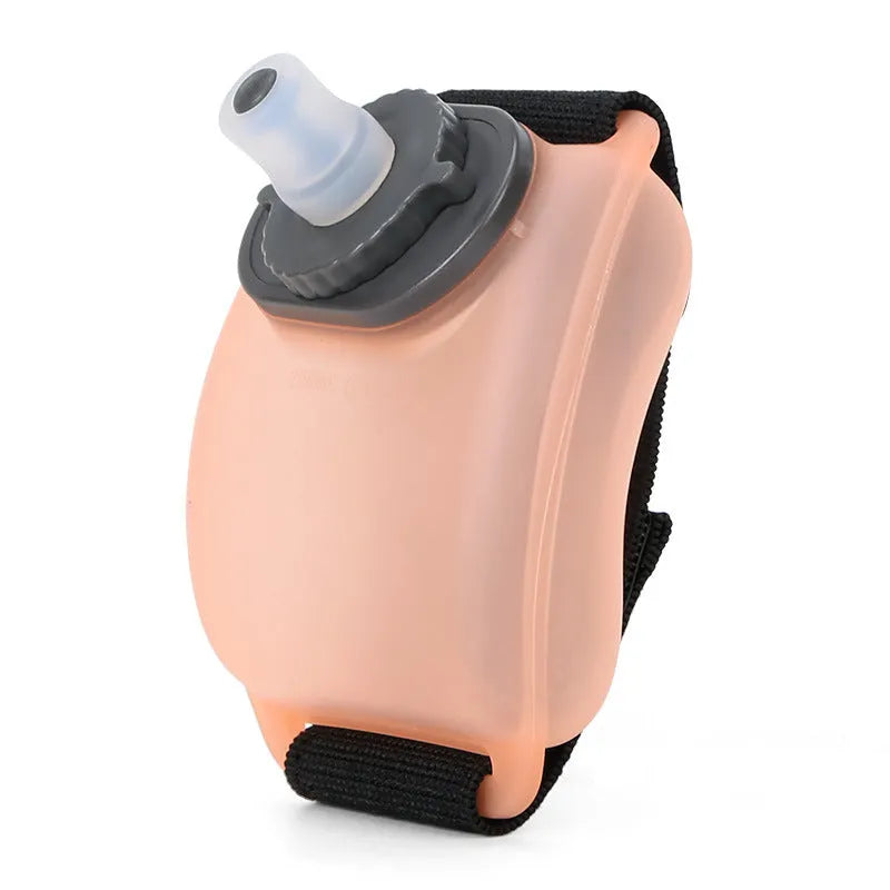 Orange silicone wrist water bottle with black Velcro strap, shown on a wrist, 200ml capacity.