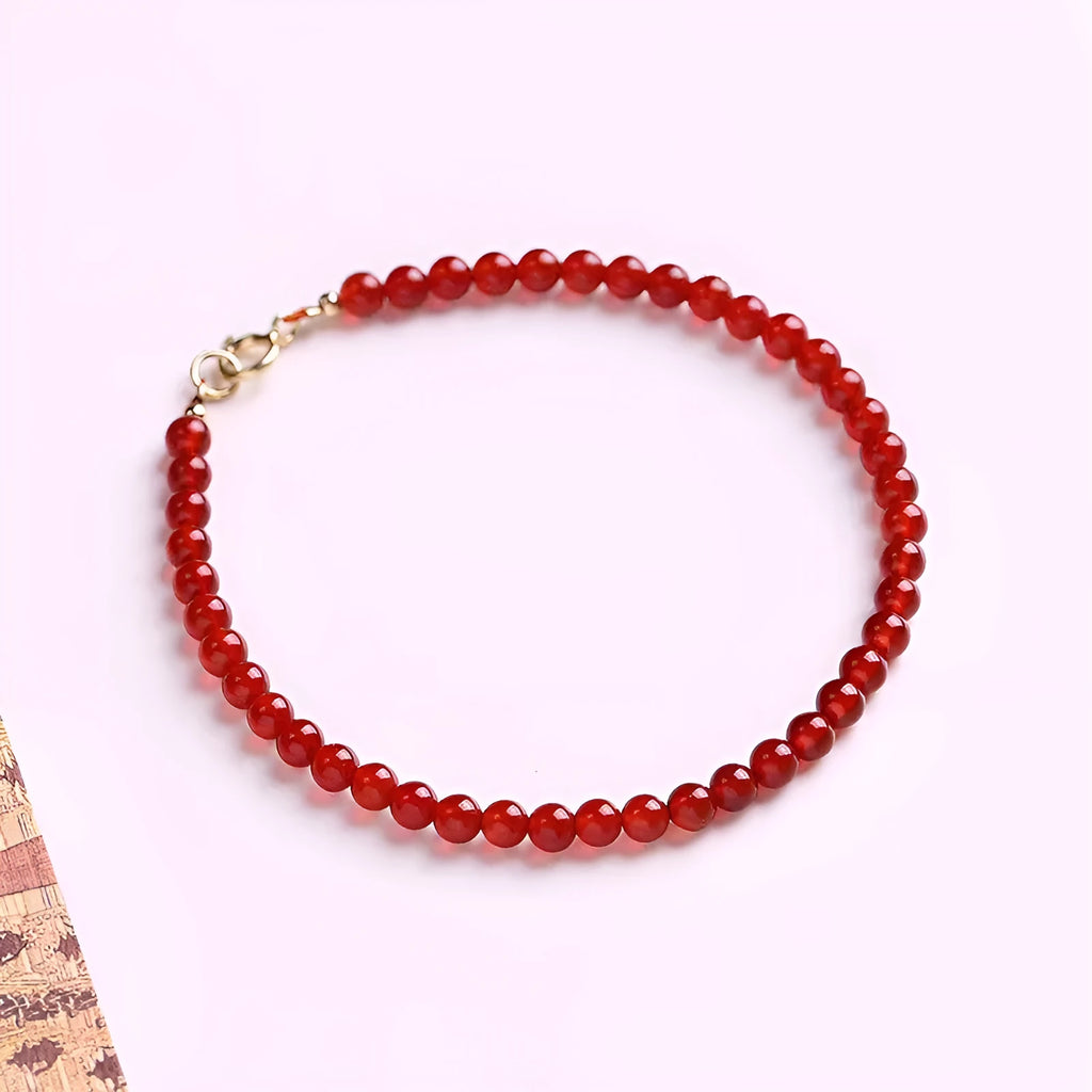 A classic style ultra-thin red agate bracelet for women on a white background.