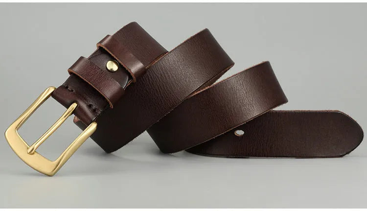 Handmade casual men's cowhide belt with needle buckle and leather decoration, black colour, on a plain background